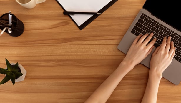 Top View Of Office Workplace. Young secretary working at wooden desk, copyspace for text or logo photo