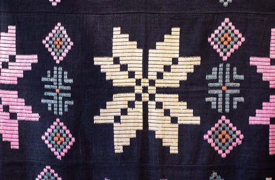 Traditional rustic tablecloth with handmade patterns and embroidery, macro photo