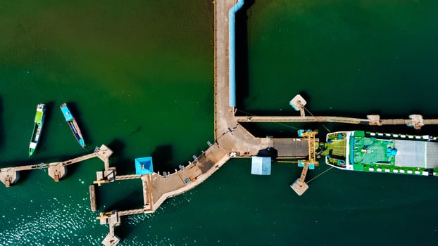 Aerial views of the harbor leading to Labuan Bajo, featuring deep blue waters and a clear sky, with boats ready to sail towards the Labuan Bajo, Indonesia photo