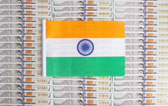 India flag on a background from dollar banknotes. Concept of the relationship of the Indian money in relation to the dollar, the country's economy, financial photo