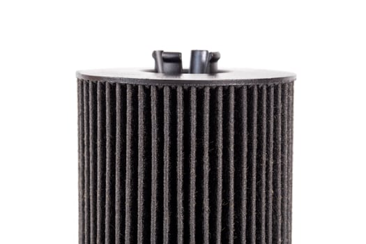Car oil filter insert on white background, isolate. The concept of cleaning oil from dirt and impurities. Close-up photo