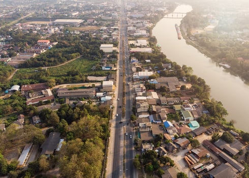 Traffic on highway with building and nature in evening photo