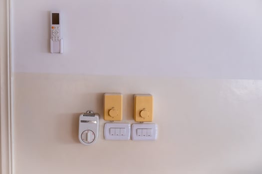 Wall with Electrical Switches and Remote Control Panel photo