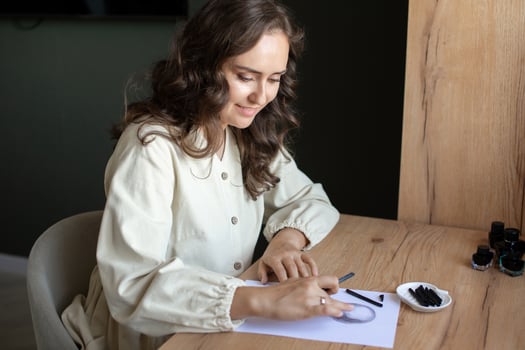 Smiling Young Woman Writing Notes in Stylish Interior photo