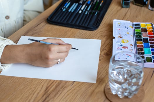 Artist Starting a Watercolor Painting on a Blank Canvas photo