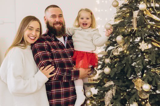 Family decorating christmas tree at home photo