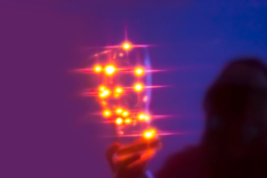 Human unrecognizable silhouette with shiny lights in a dark room photo