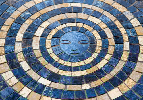 Intricate mosaic tile pattern with sun symbol photo