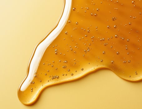 Close up of bubbly golden honey photo