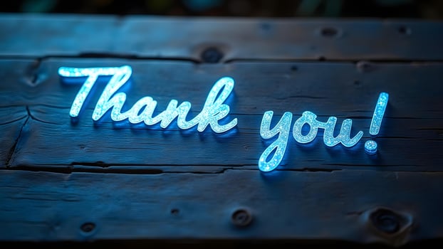 Glowing Thank You Note on Rustic Wooden Surface photo