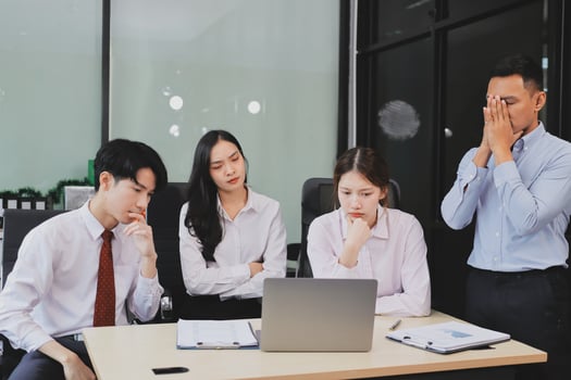 Frustrated upset multiracial business team people sad with bad work result in report disappointed in corporate bankruptcy failure crisis worried of paperwork problem sit at table at office meeting photo