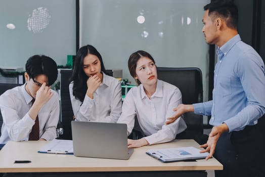 Frustrated upset multiracial business team people sad with bad work result in report disappointed in corporate bankruptcy failure crisis worried of paperwork problem sit at table at office meeting photo