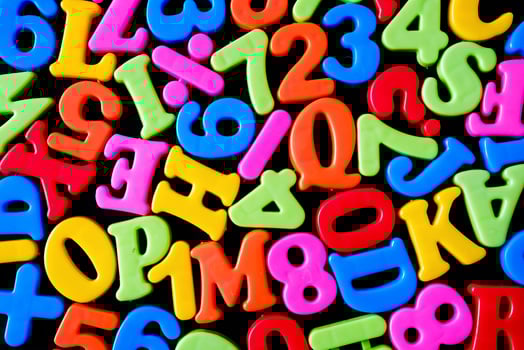 Background with letters and symbols as a school education concept. Cheerful bright letters. photo