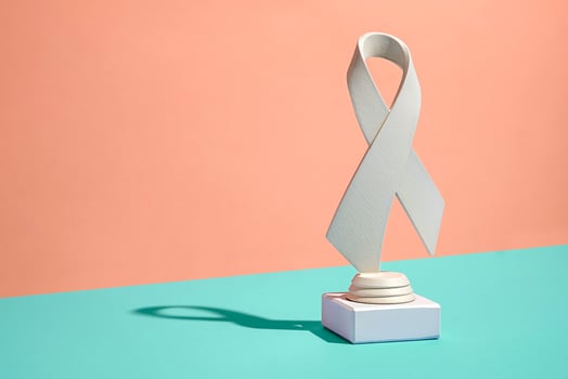 Symbolic pure white ribbon trophy over a bicolor background photo