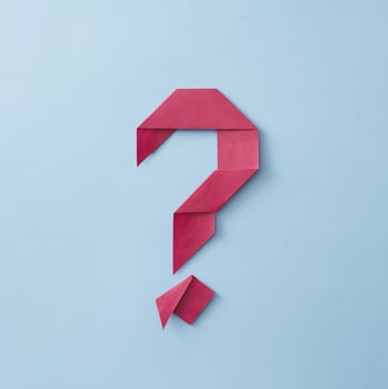 Neatly folded origami red paper question mark photo