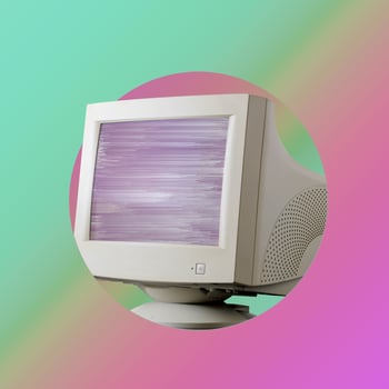 On velvet purple and green background is retro monitor with glitch on screen. photo