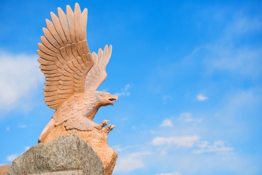 Sand stone sculpture of eagle flying photo