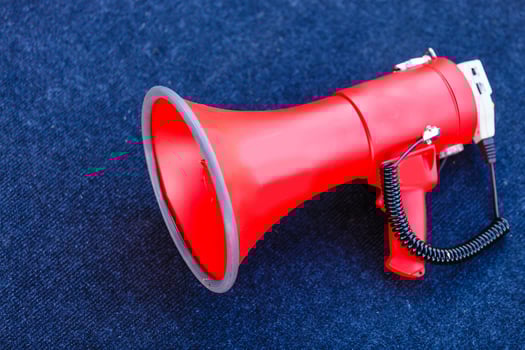 Megaphone on a blue background. Copy space. photo