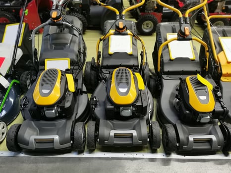 Lawn mowers are sold in the shop. Garden equipment in stock in the store. photo