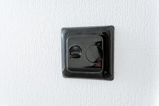 Closeup of a black electrical outlet on a white wall photo