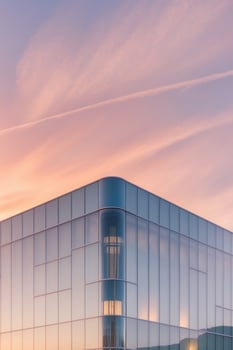 A building with a large glass facade at sunset photo