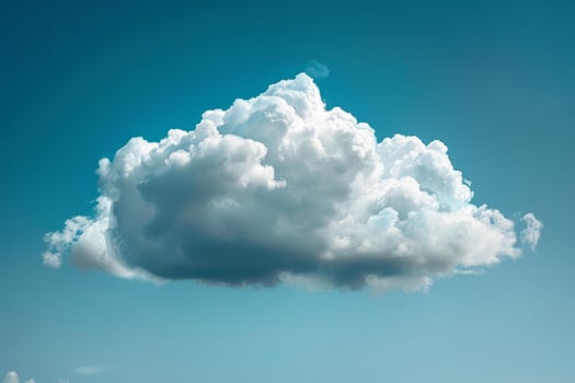 Big fluffy white cumulus cloud is floating in the bright blue sky photo