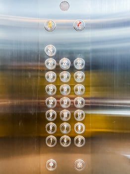 Close up of elevator panel with metallic finish and push buttons photo