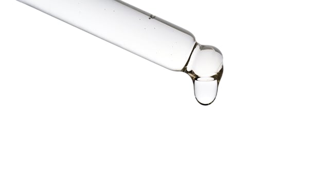 Dropper pipette with delicious serum with bubbles close-up. photo