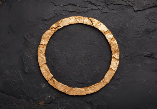 Cracked golden ring on dark slate background photo