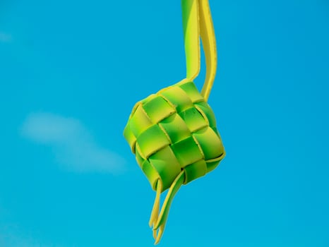 As a celebratory dish, ketupat is packaged in organic green packaging and can be served at Islamic celebrations such as Eid al-Fitr photo