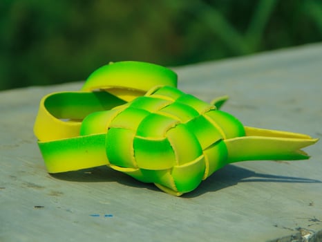 As a celebratory dish, ketupat is packaged in organic green packaging and can be served at Islamic celebrations such as Eid al-Fitr photo