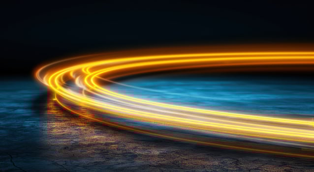 Swirling light trails over a dark landscape photo