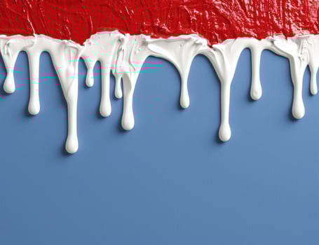 Dripping red paint on blue background photo