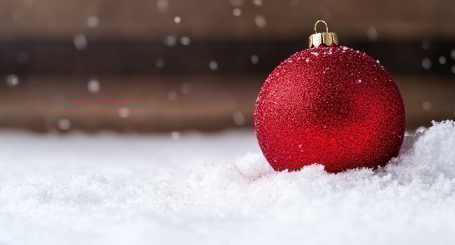 Sparkling red christmas ornament in snow photo