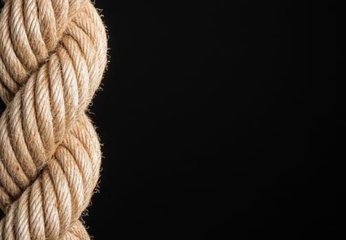 Coiled rope on black background photo