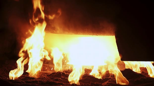 A Fiery Blaze Emanates from the Molten Metal Pouring in a Fiery Workshop Setting. Stock Clip photo