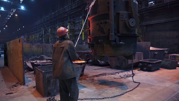 An Industrial Worker Concentrating on Operating Heavy Machinery Within a Factory Setting. Stock Clip photo