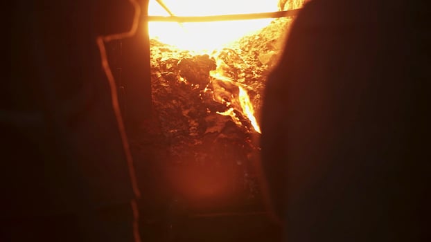 Engaging in Crafting Activities Within the Blazing Heat of the Furnace Environment. Stock Clip photo