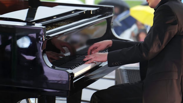 An Elegant Pianist Graces the Stage While Performing at a Lovely Outdoor Event, Captivating All. Clip photo