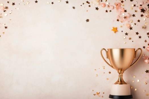 Celebration with a golden trophy and gift box surrounded by glittering stars and ribbons photo