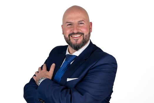 portrait of businessman in blue suit and tie with friendly expression isolated on white background photo