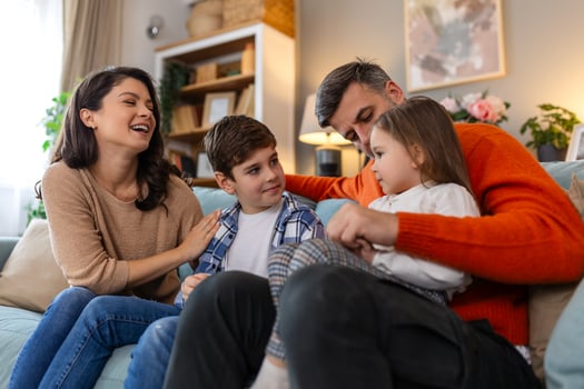 A family sitting on a couch together photo