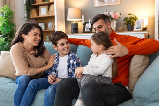 A family sitting on a couch together photo