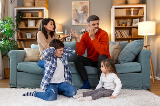Divorce And Domestic Violence. Portrait of upset son and daughter while their angry parents fighting in the background, depressed children feeling lonely photo