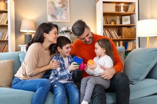 A family sitting on a couch with toys photo