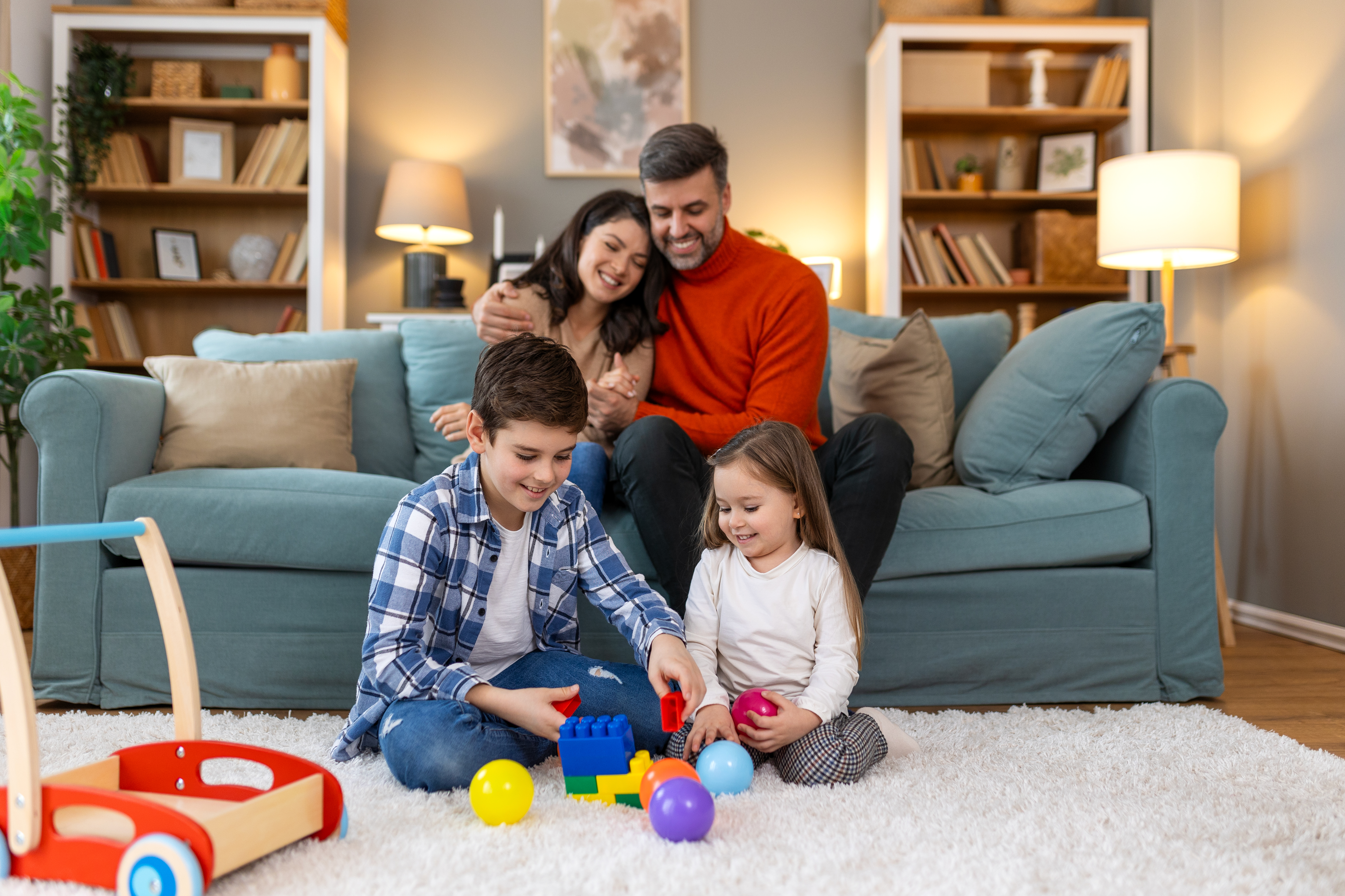A family playing with toys on a couch photo