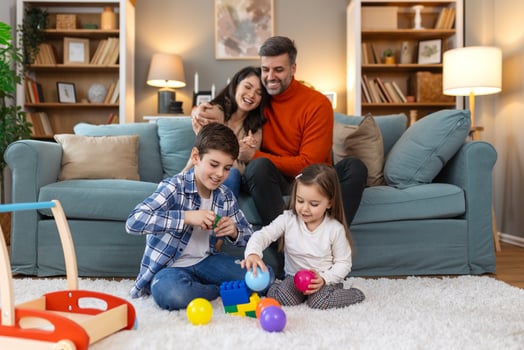 A family sitting on a couch playing with toys photo