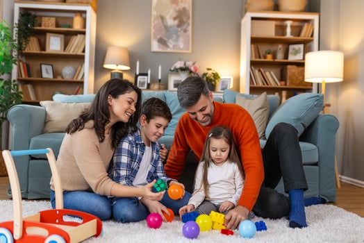 A family playing with toys in their living room photo