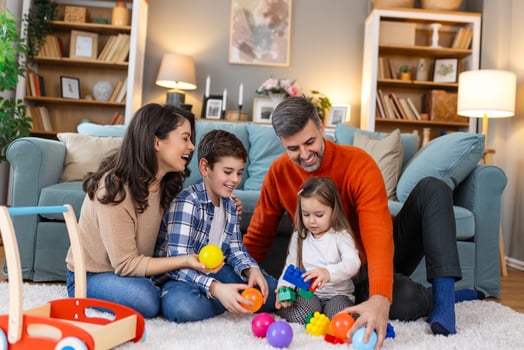 A family playing with toys in the living room photo