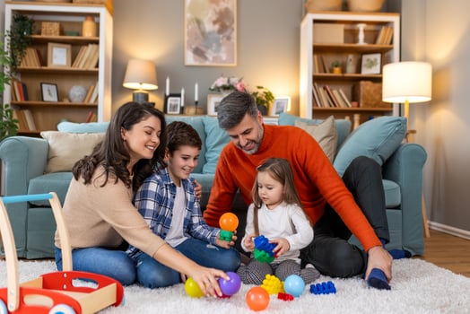 A family playing with toys in their living room photo